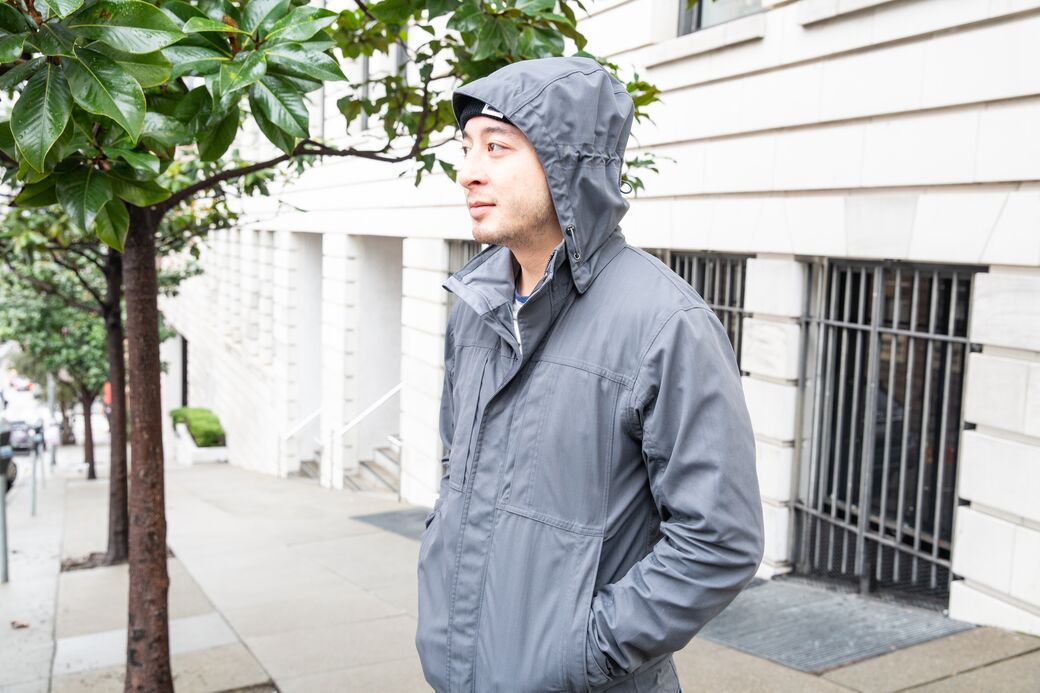Man wearing hooded rain jacket