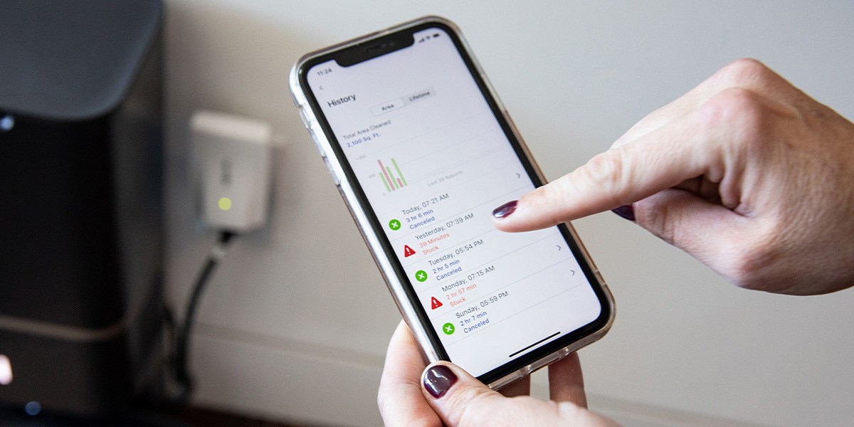 Person using app to operate robotic vacuum