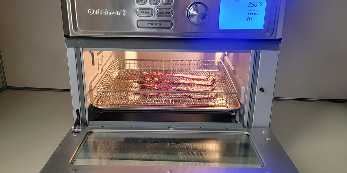 Cuisinart Digital Air Fryer Toaster Oven  on counter with door open and bacon on cooking rack